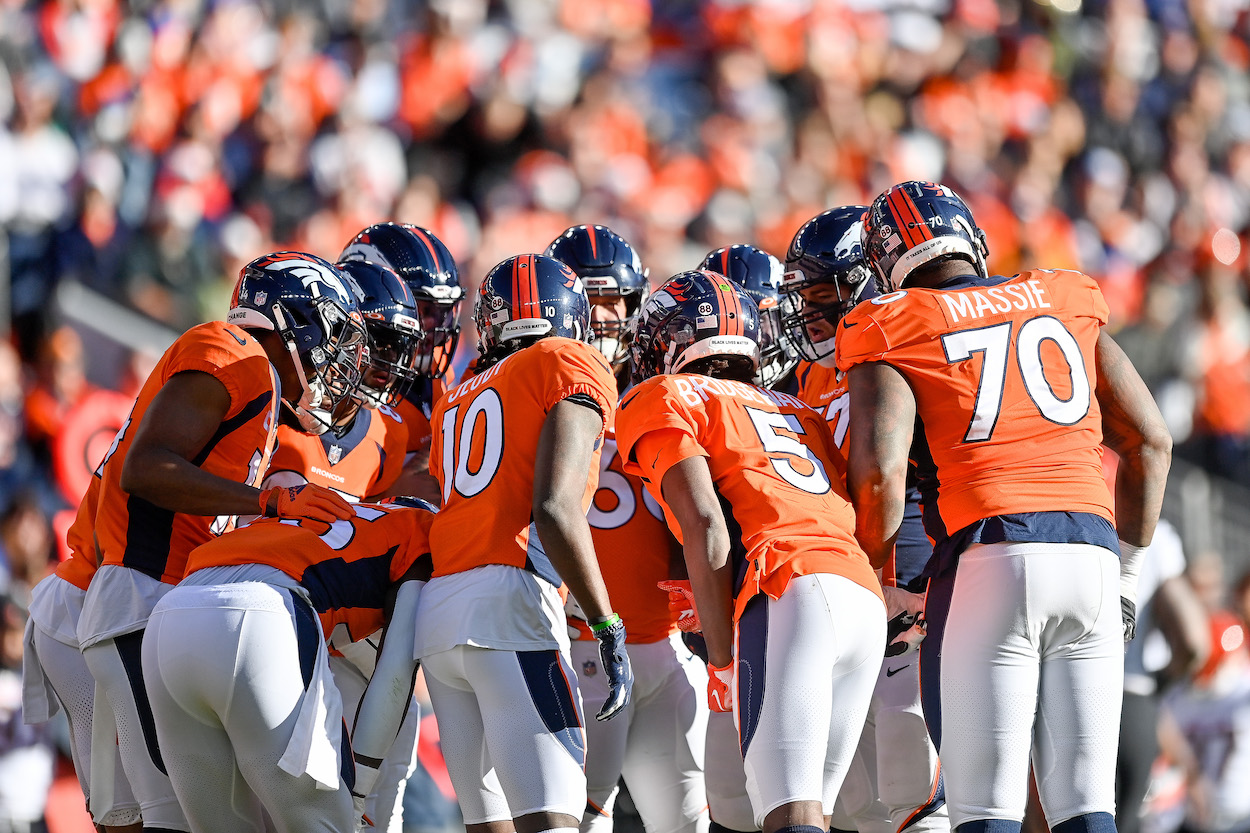 The Denver Broncos offense huddling during a 2021 game.