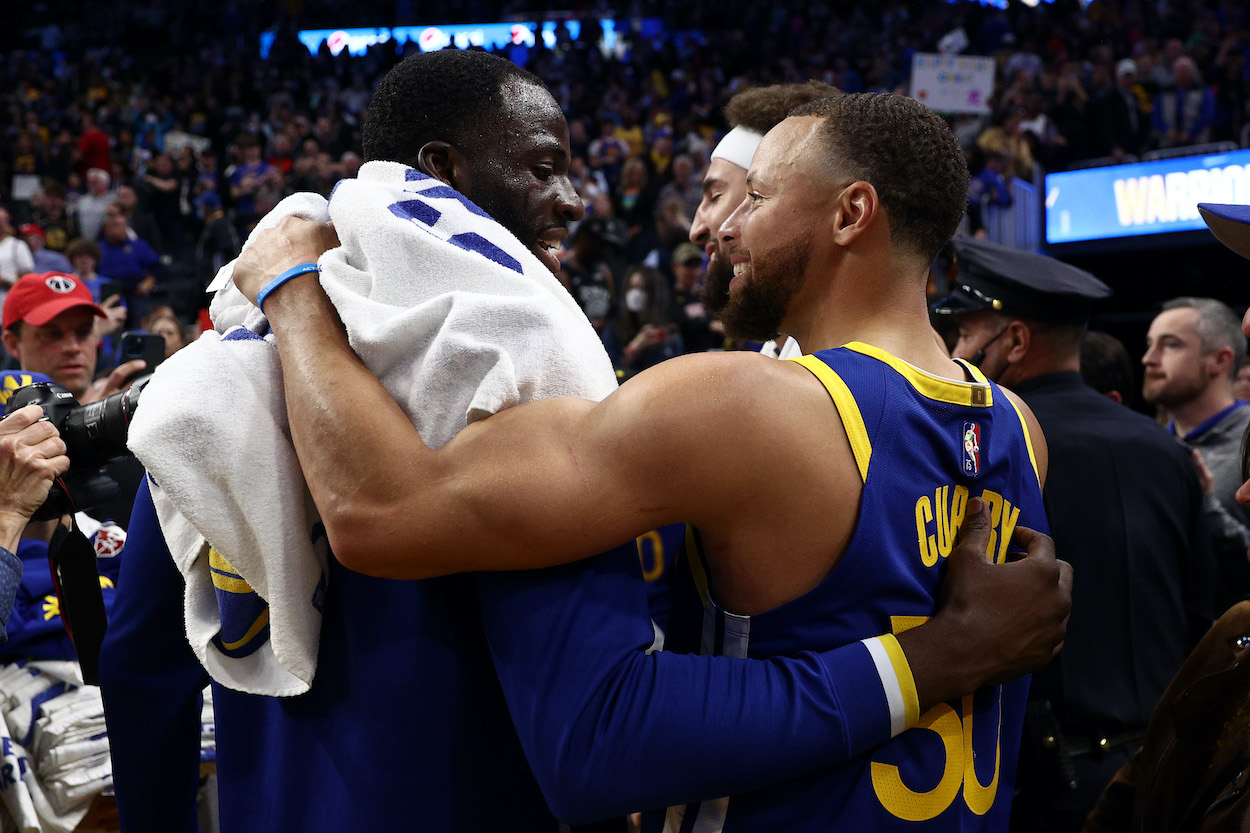 Draymond Green and Stephen Curry embrace.