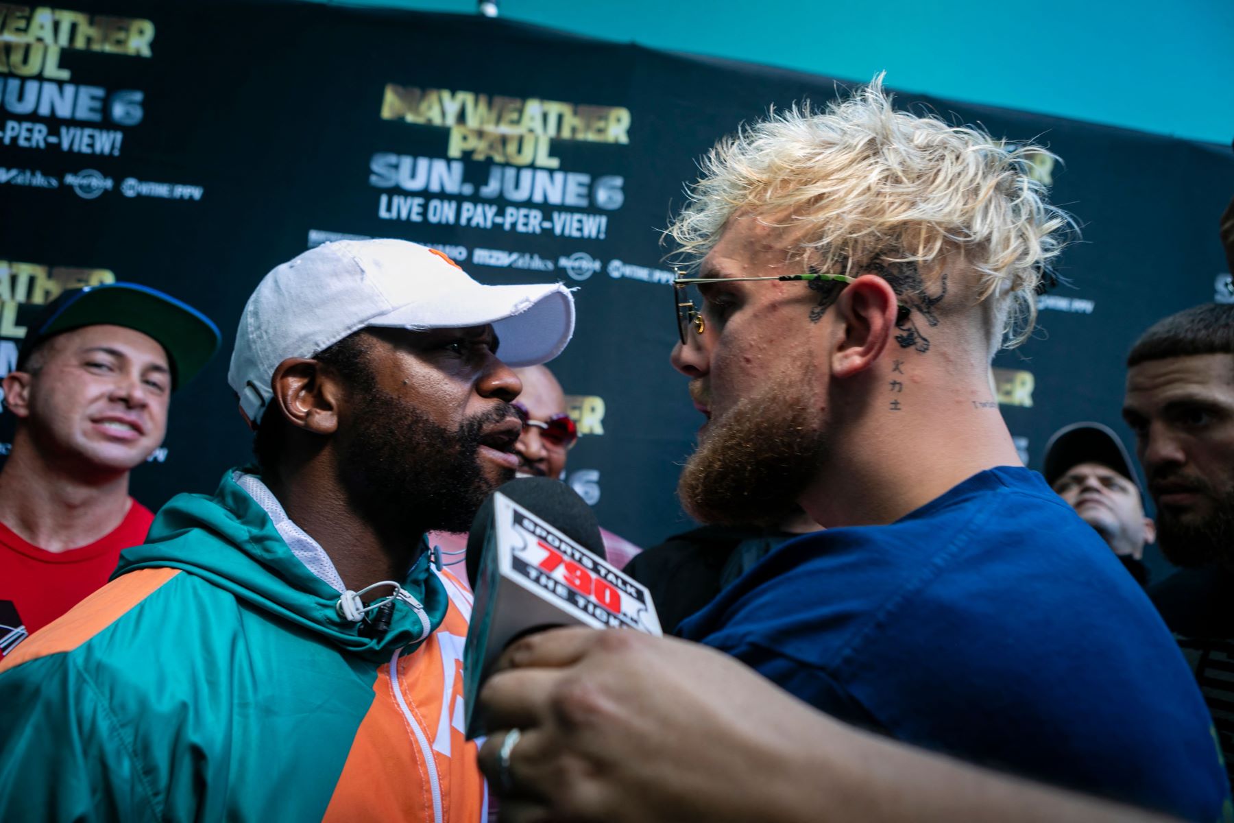 Floyd Mayweather Jr. and Jake Paul staring each other down before the Logan Paul vs Mayweather fight in Miami, Florida