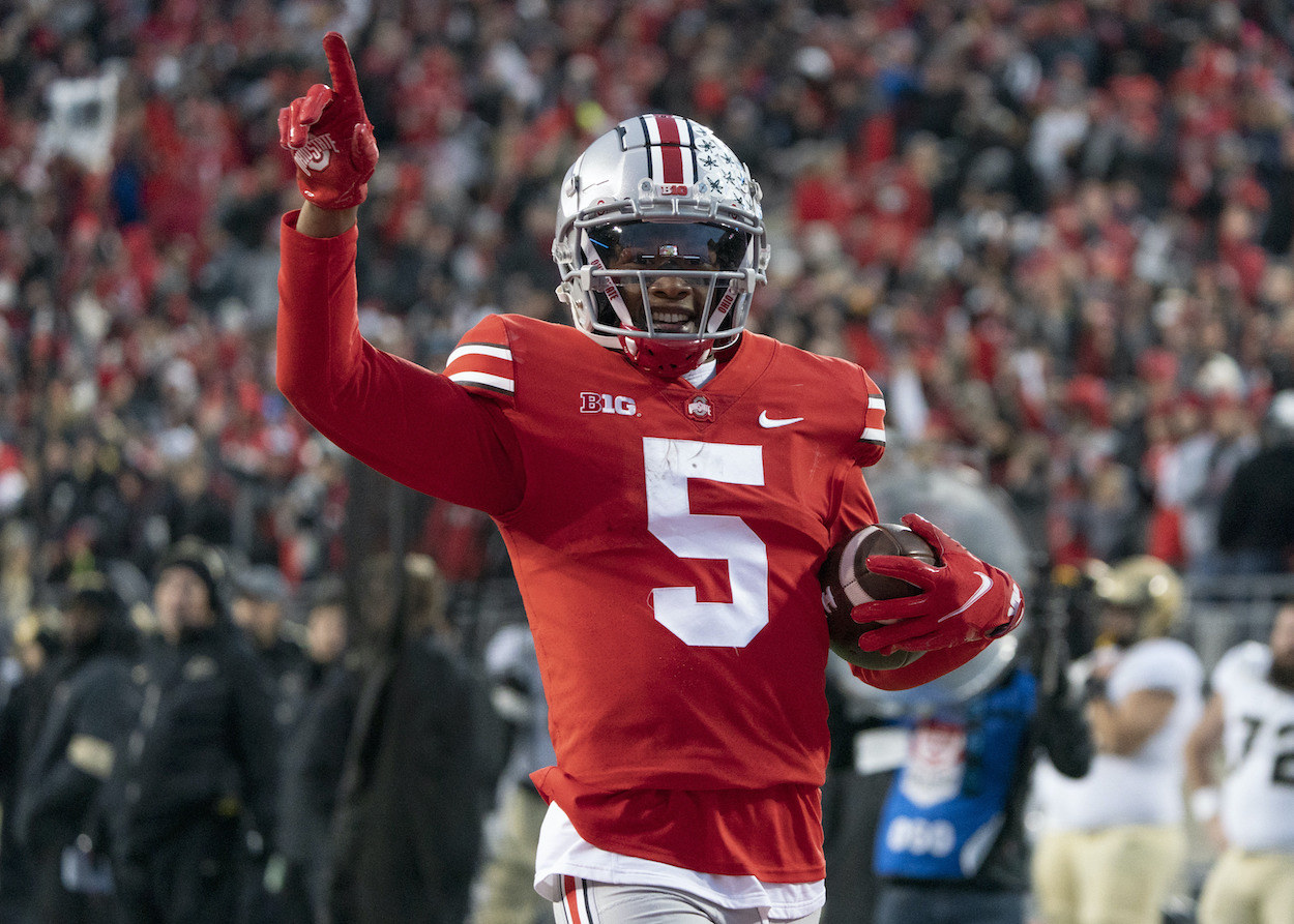 Ohio State Buckeyes wide receiver Garrett Wilson celebrating. Mel Kiper Jr. has the Atlanta Falcons taking Wilson No. 8 in the NFL draft.