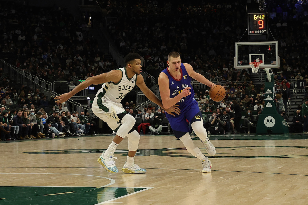 Nikola Jokic drives against Giannis Antetokounmpo