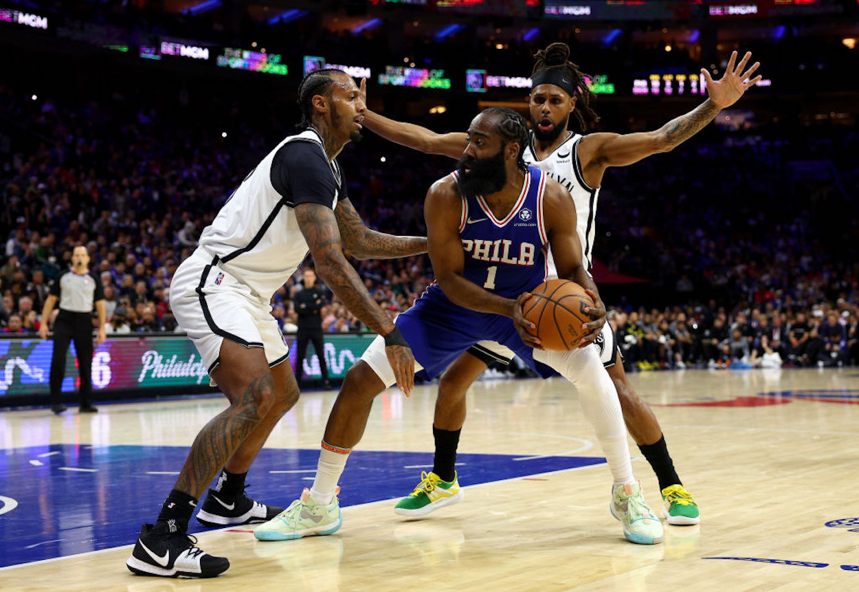 James Harden faces two Brooklyn Nets defenders.