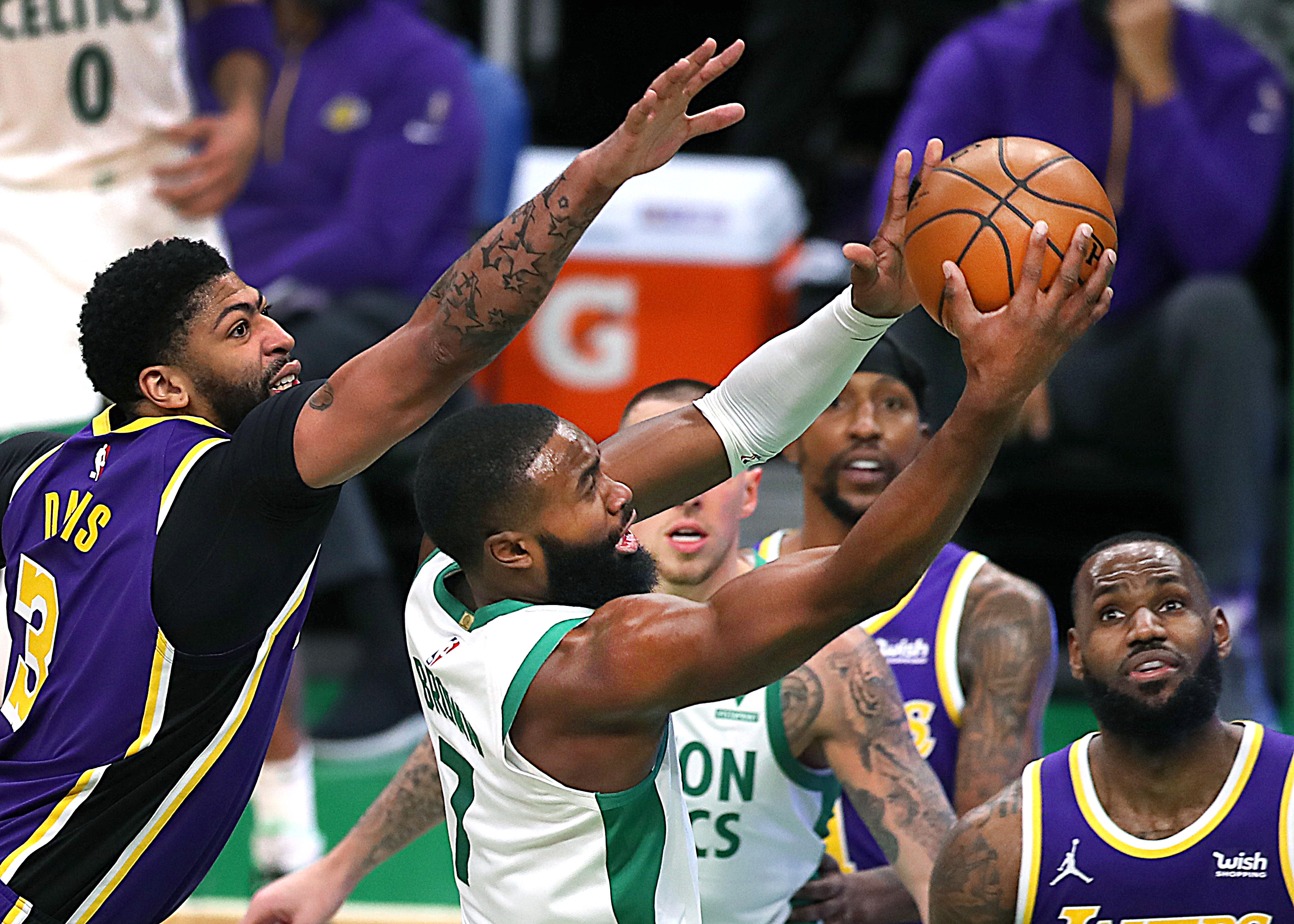 Boston Celtics wing Jaylen Brown drives as Los Angeles Lakers forward Anthony Davis defends during an NBA game in January 2021