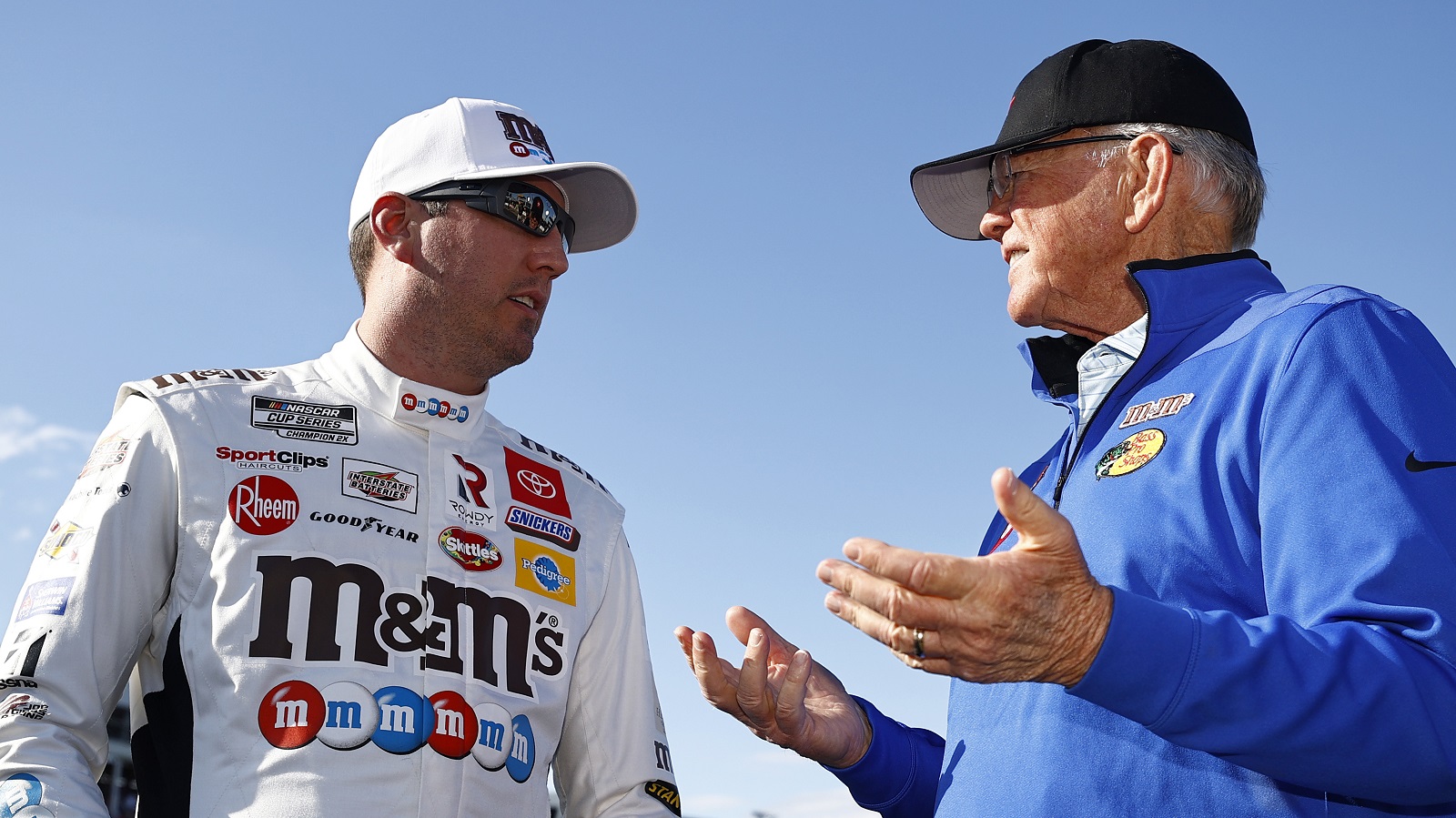 Kyle Busch, driver of the No. 18 Toyota, and Hall of Famer and team owner Joe Gibbs talk on the grid prior to the NASCAR Cup Series Coca-Cola 600 at Charlotte Motor Speedway on May 30, 2021.