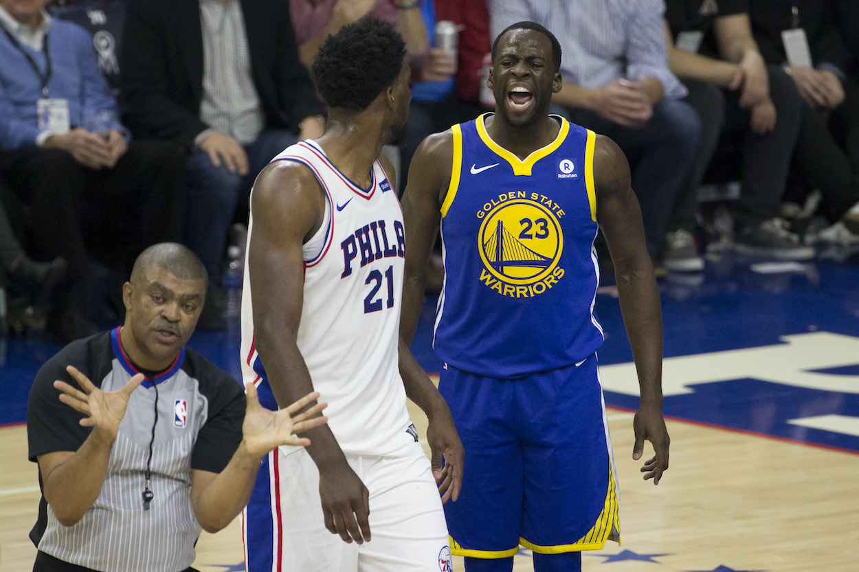 Draymond Green yells in front of Joel Embiid.