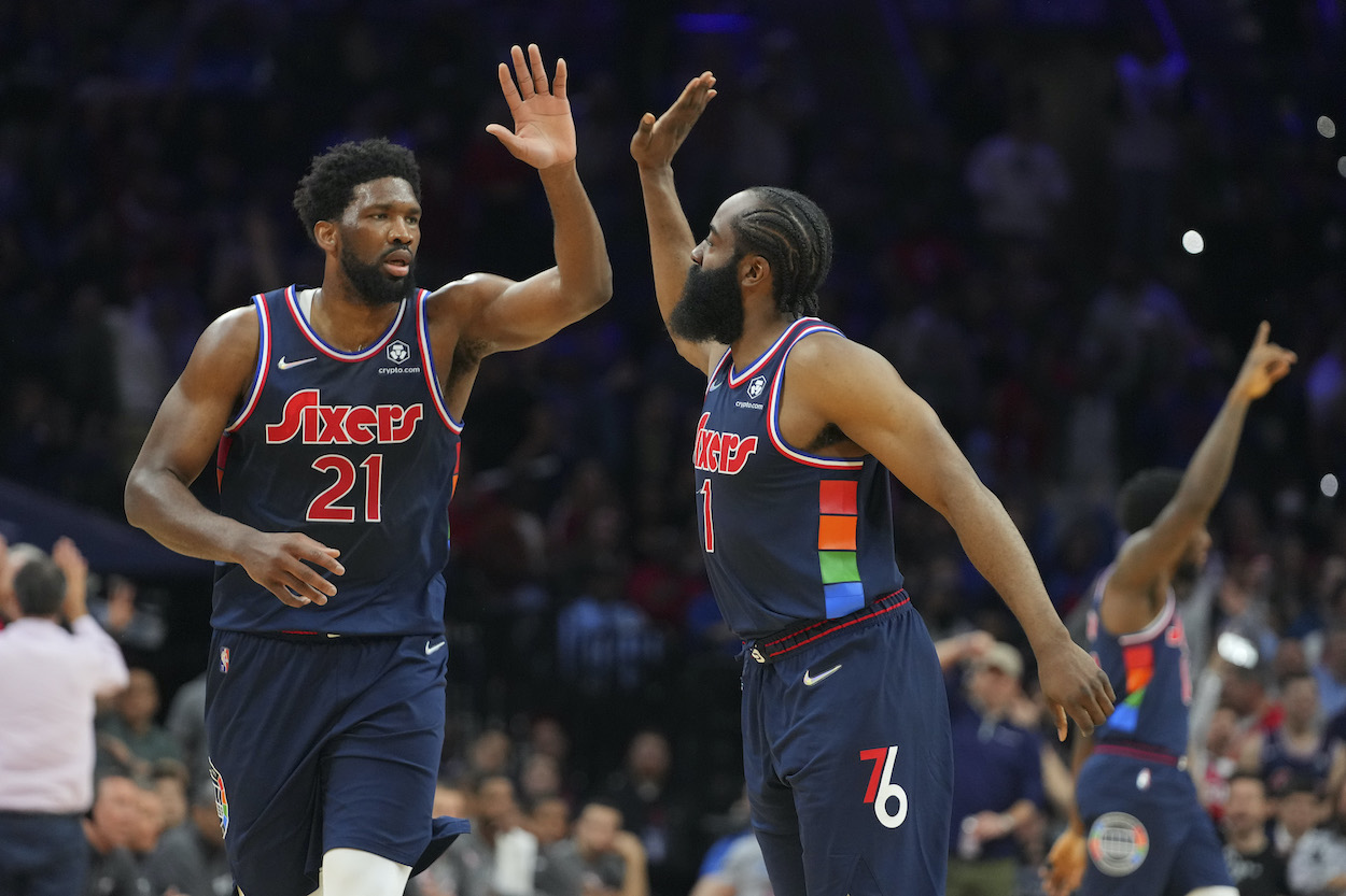 Joel Embiid high fives James Harden.