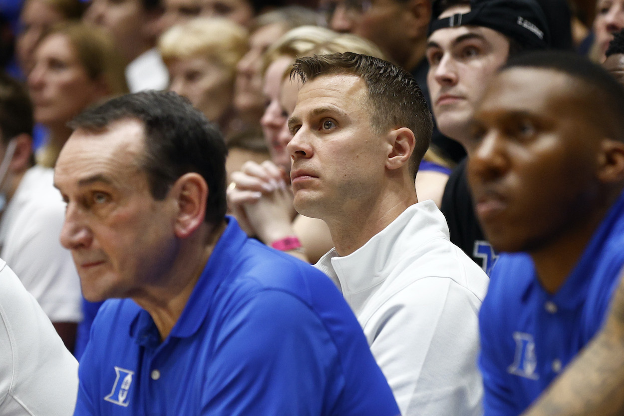 Jon Scheyer looks on behind Coach K.