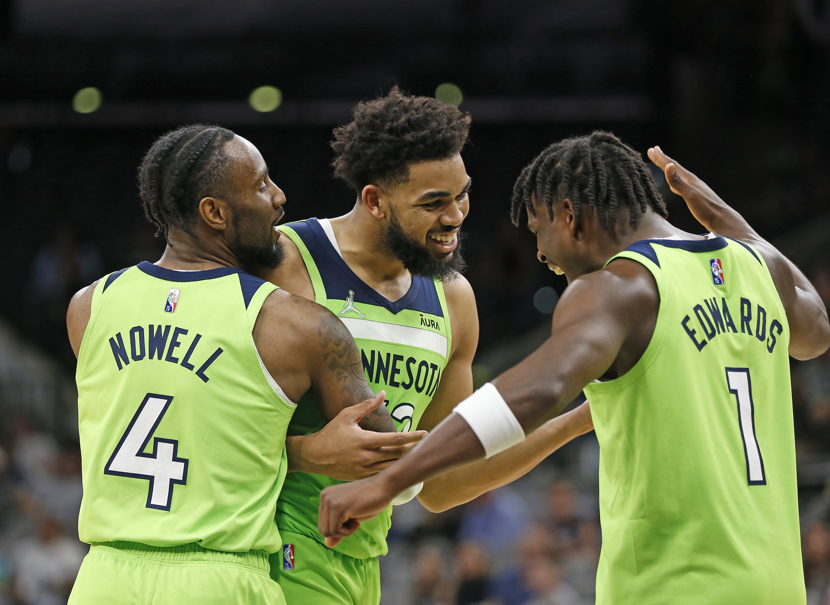 Minnesota Timberwolves star Karl-Anthony Towns (center) celebrates with teammates after scoring 60 points in an NBA game against the San Antonio Spurs in March 2022