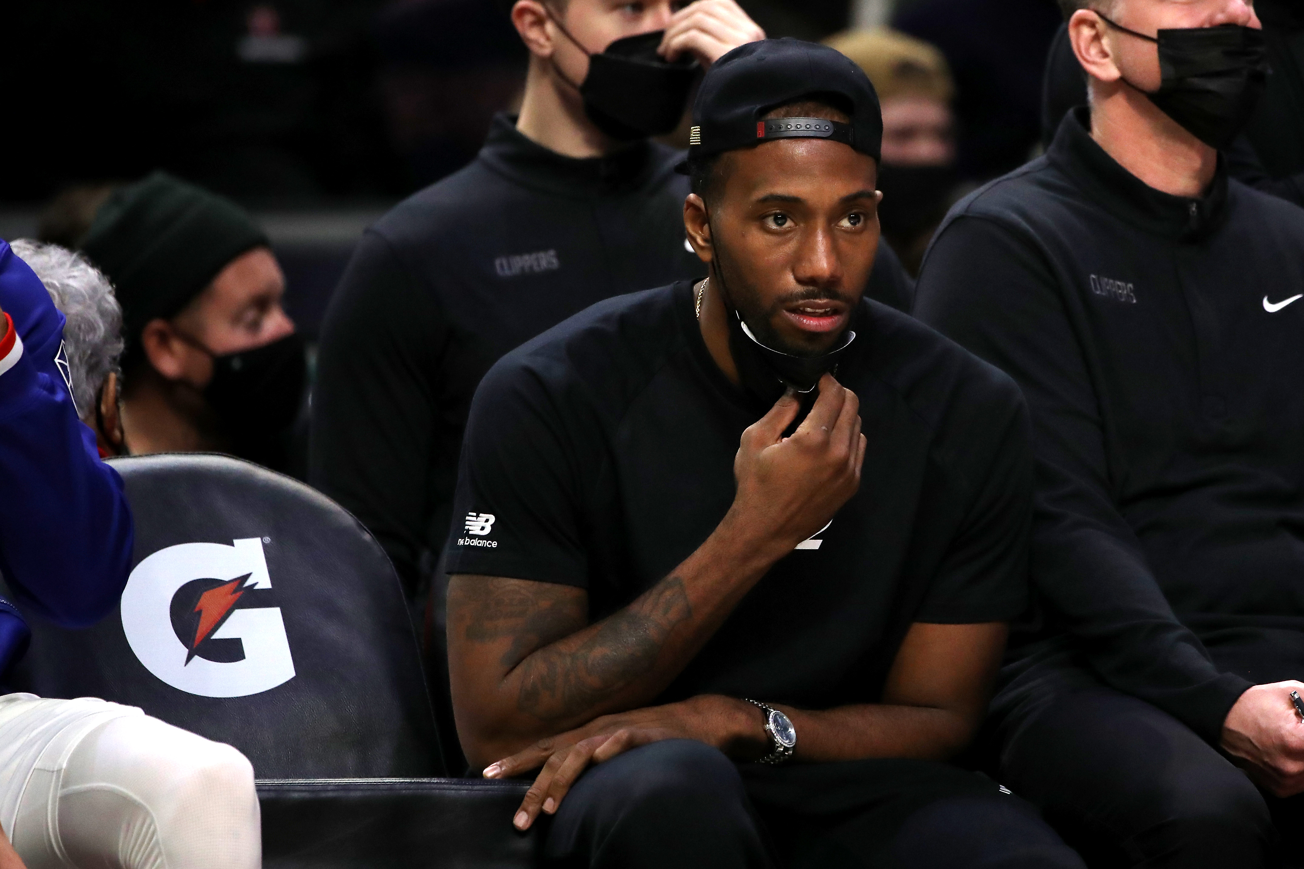 Los Angeles Clippers star Kawhi Leonard looks on from the bench during an NBA game against the Denver Nuggets in December 2021
