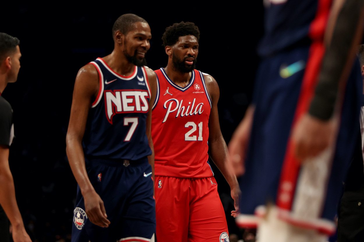 Kevin Durant and Joel Embiid look on during a game.