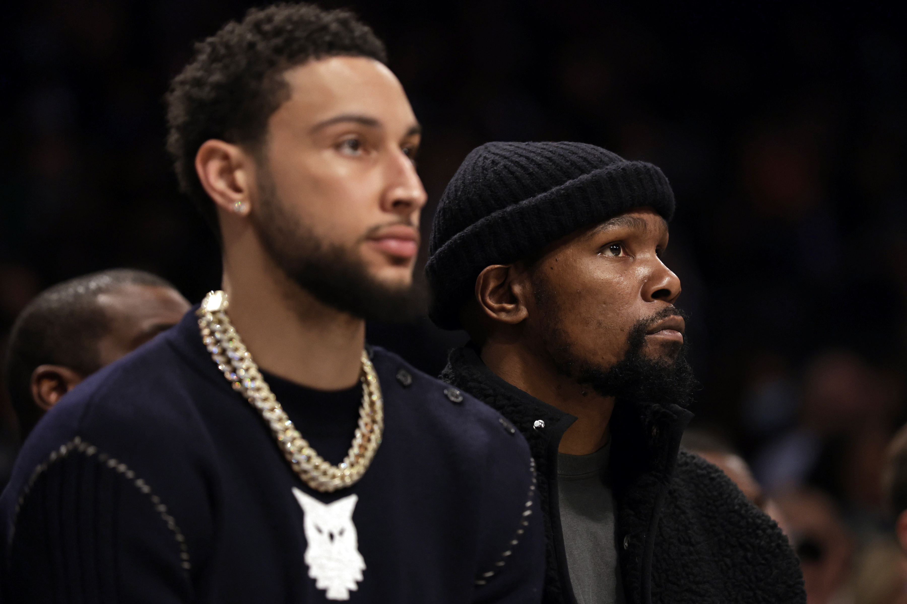 Brooklyn Nets stars Kevin Durant (R) and Ben Simmons (L) look on during an NBA game in February 2022