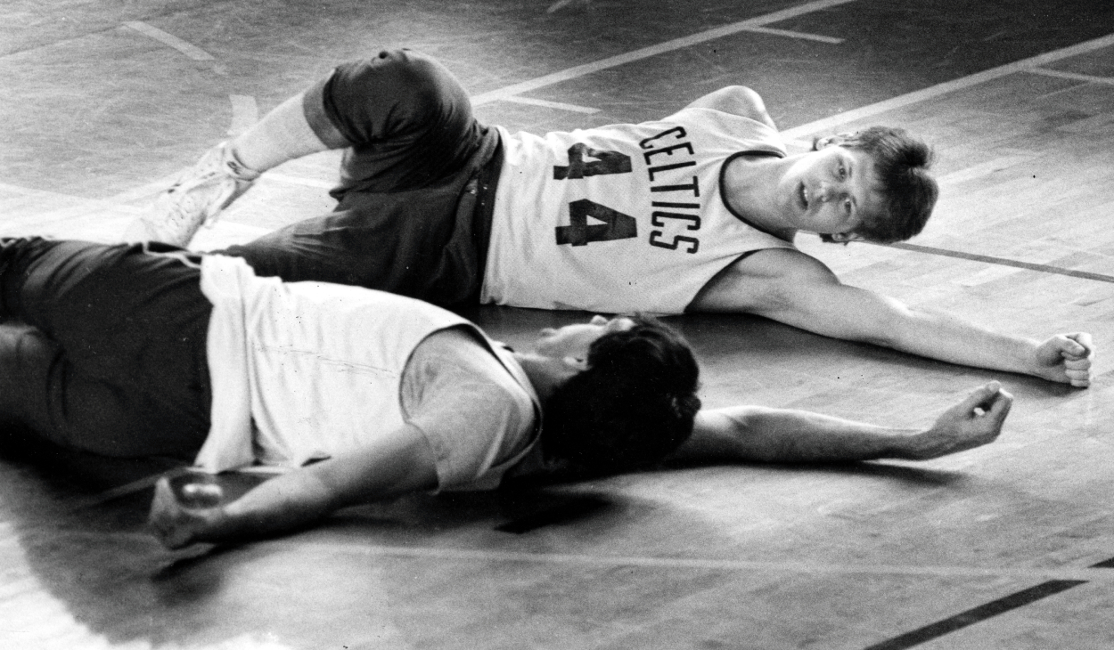 Boston Celtics' Danny Ainge and Kevin McHale participate in stretching exercises.