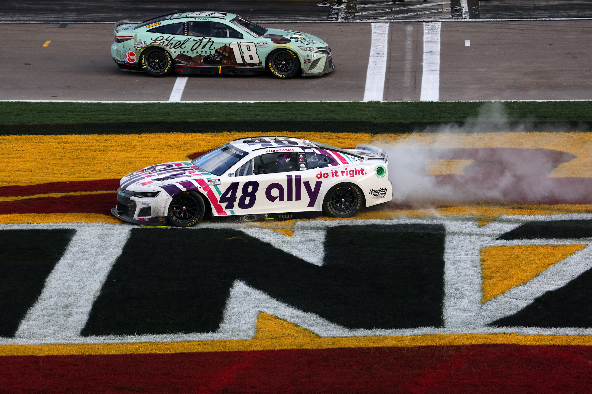 Kyle Busch drives by Alex Bowman