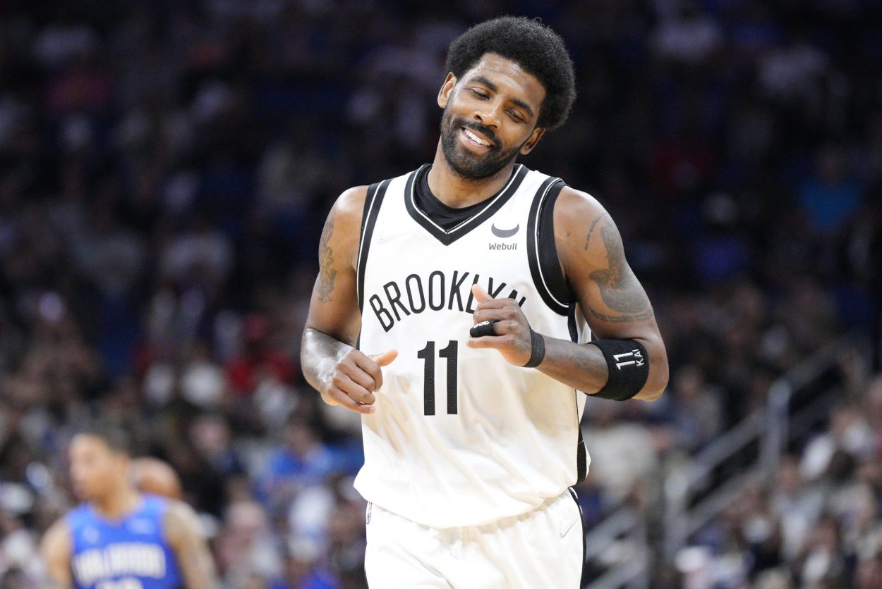 Brooklyn Nets star Kyrie Irving smiles during an NBA game against the Orlando Magic in March 2022