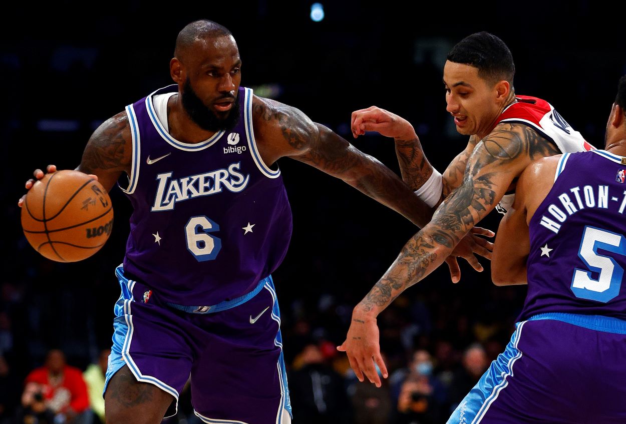 Los Angeles Lakers forward LeBron James attempts to dribble past Wizards forward Kyle Kuzma.