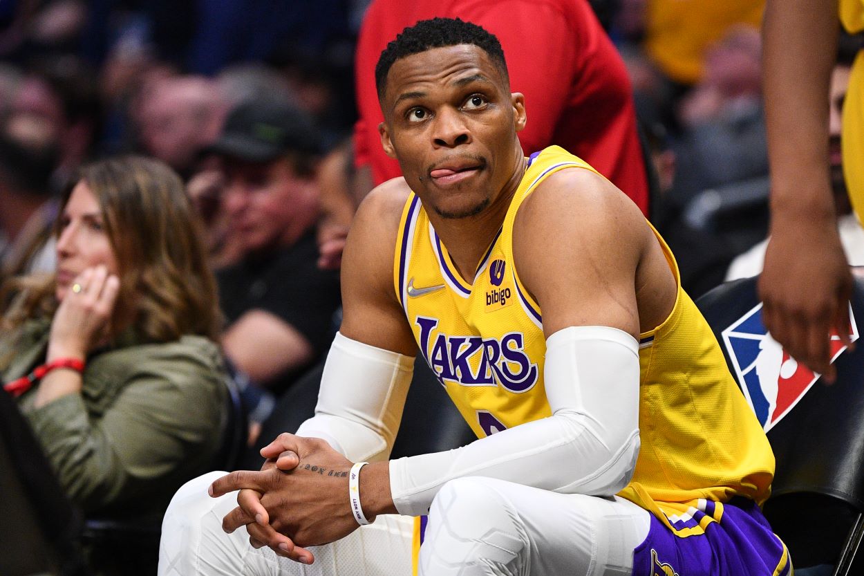 Lakers point guard Russell Westbrook looks on from the bench during an NBA game against the Clippers.