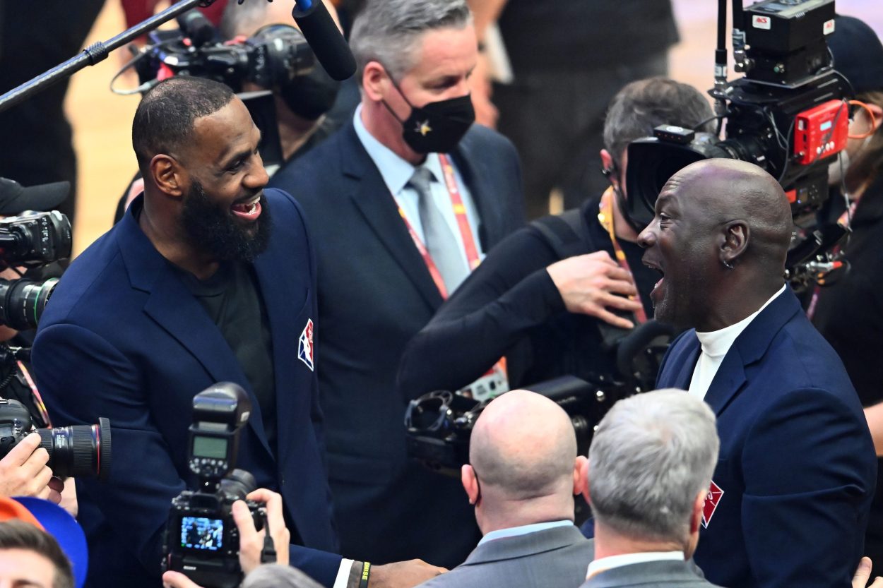 Los Angeles Lakers star LeBron James (L) speaks wit Chicago Bulls legend Michael Jordan at halftime of the 2022 NBA All-Star Game