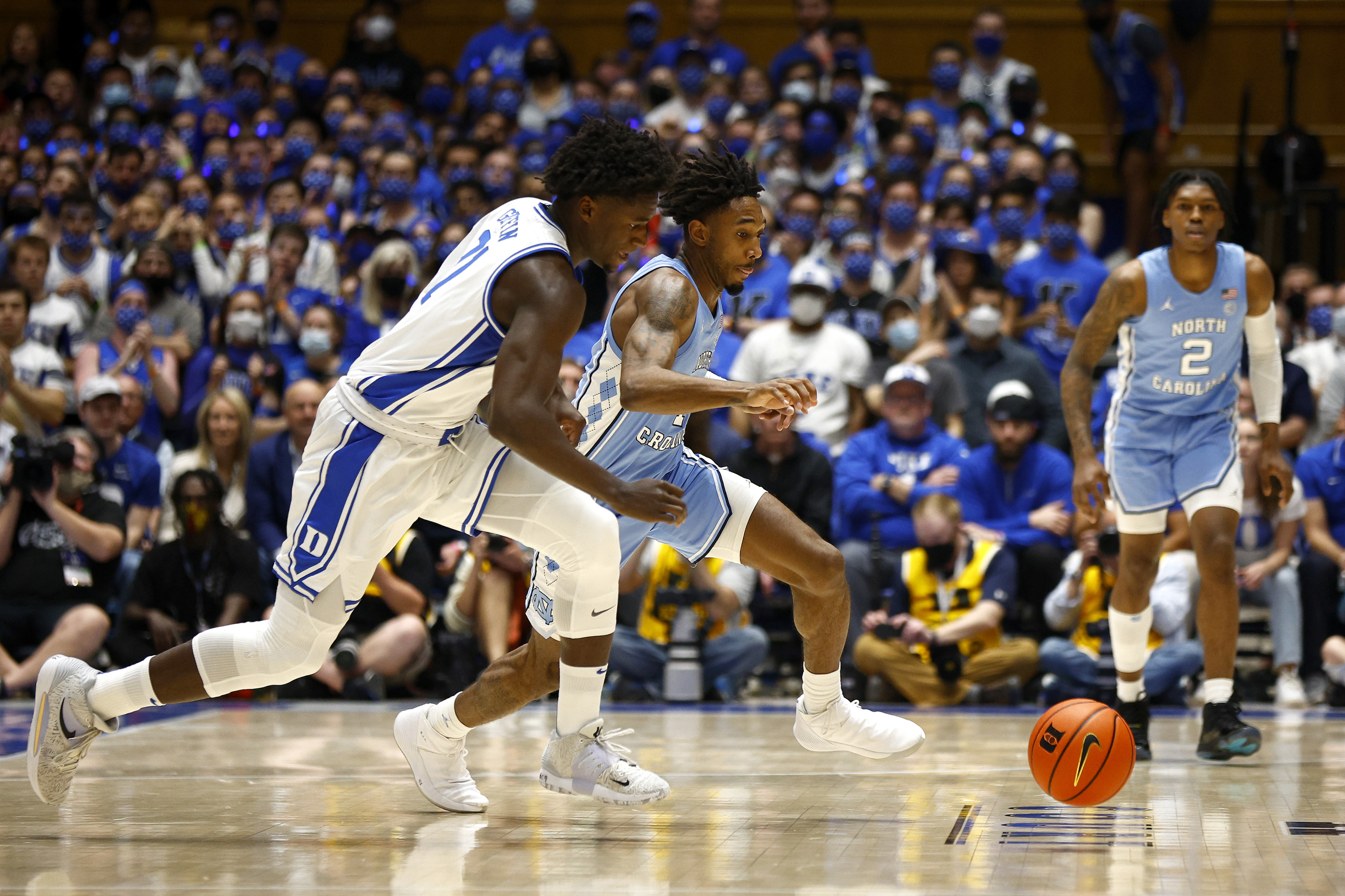 Duke's AJ Griffin and North Carolina forward Leaky Black go after a loose ball during an NCAA men's basketball game in March