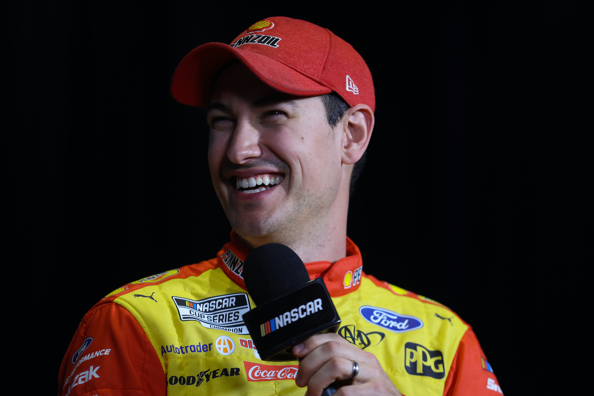 Joey Logano talks to media