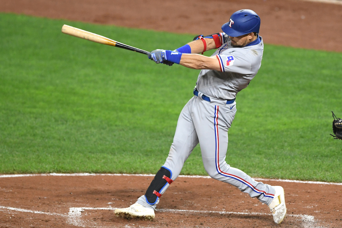 Nathaniel Lowe follows through on a swing for the Texas Rangers