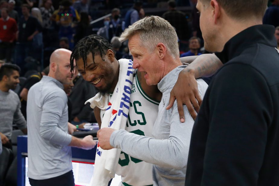 Marcus Smart of the Boston Celtics talks to head coach Steve Kerr of the Golden State Warriors after their game.