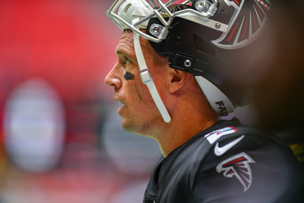 Matt Ryan rests his helmet on his head for the Atlanta Falcons