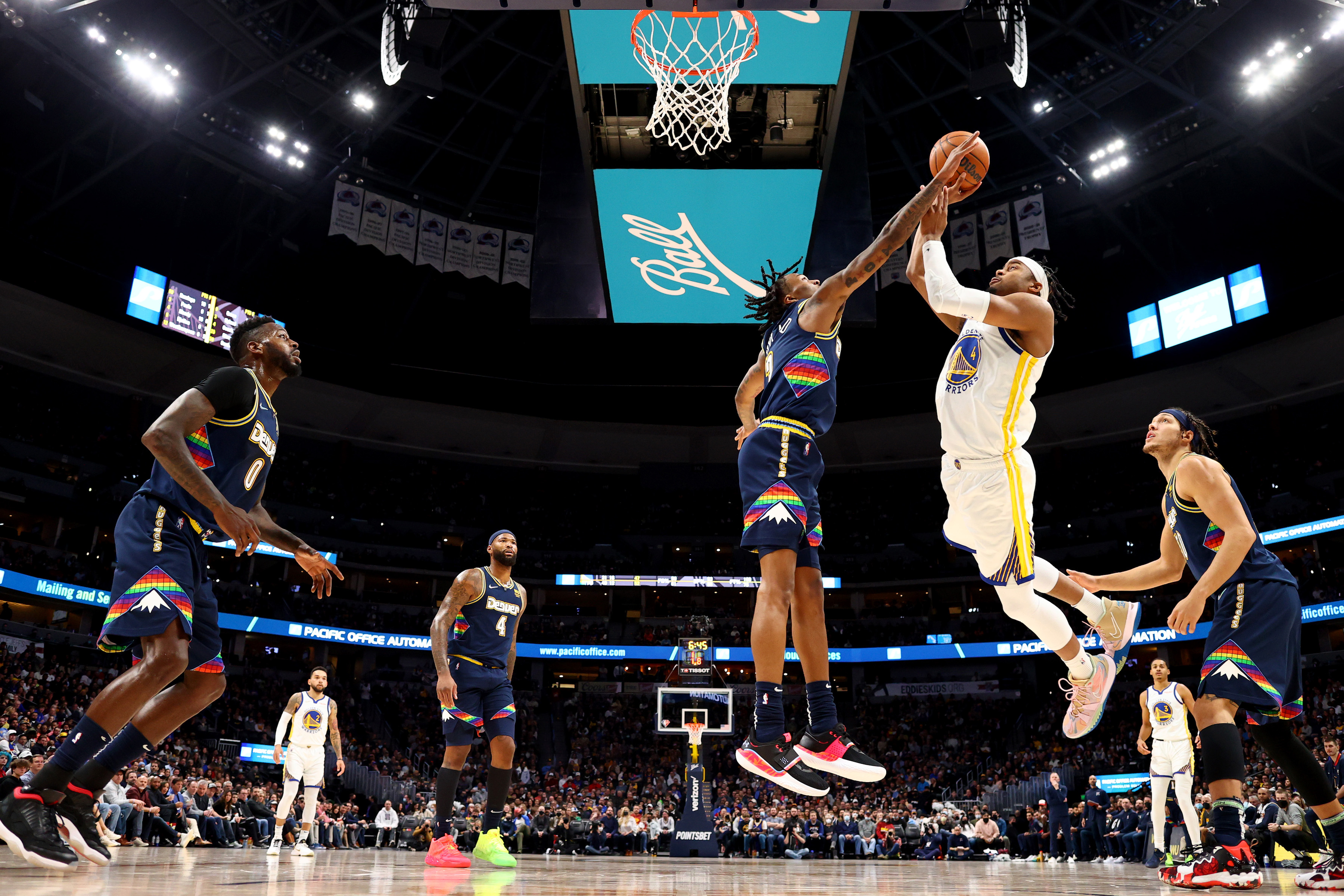 Golden State Warriors rookie Moses Moody #4 shoots over Denver Nuggets guard Bones Hyland #3 during an NBA game in March 2022