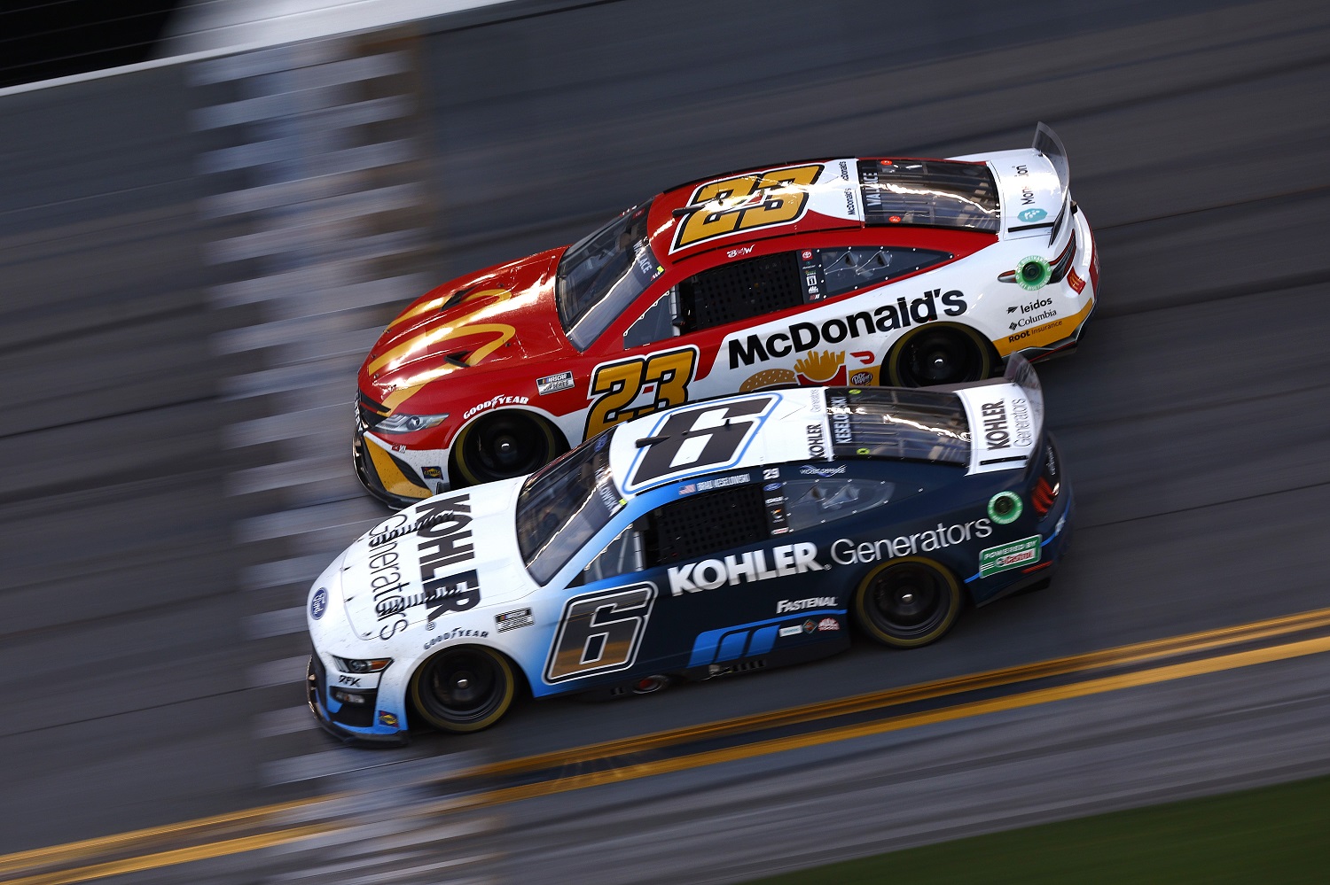 Brad Keselowski, driver of the No. 6 Ford, and Bubba Wallace, driver of the No. 23 Toyota, race during the NASCAR Daytona 500 at Daytona International Speedway on Feb. 20, 2022.