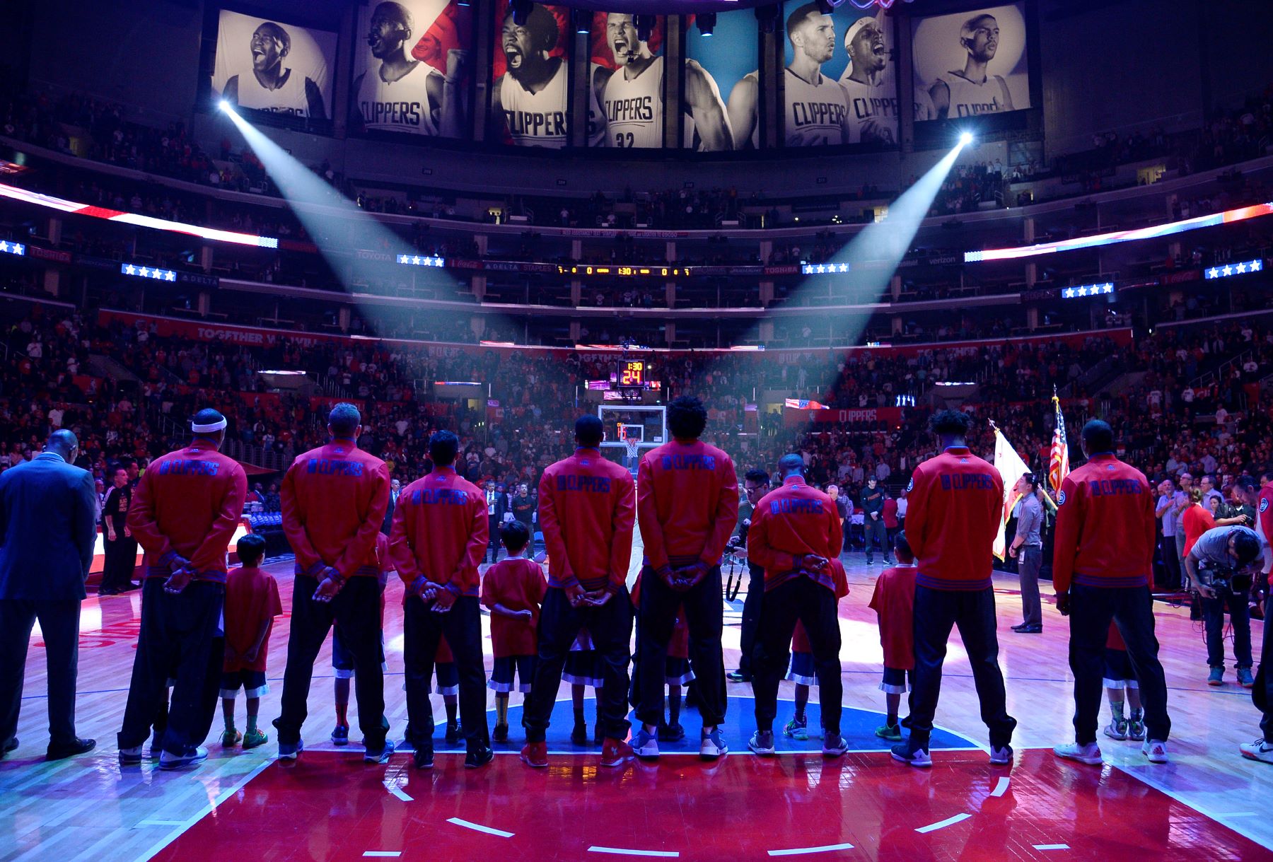 NBA players of the Los Angeles Clippers lineup for the national anthem before a game against the Phoenix Suns