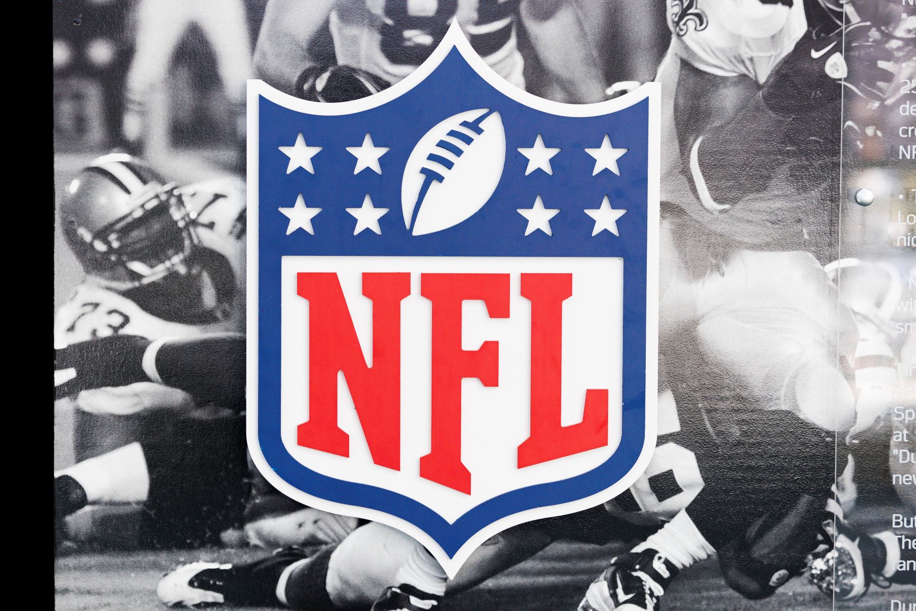 NFL logo on top of a black and white photo of past NFL players