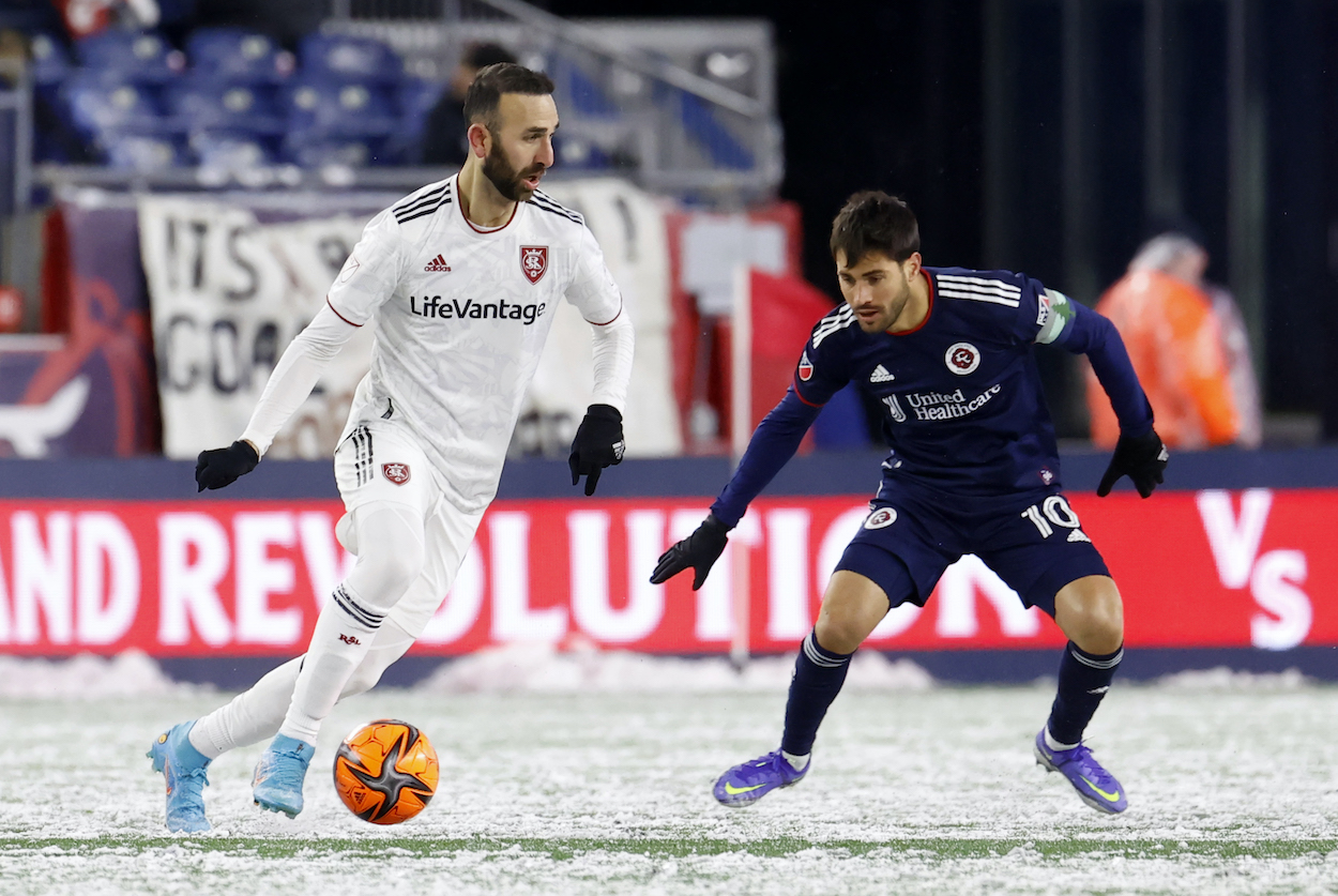 Real Salt Lake midfielder Justin Meram watched by New England Revolution forward Carles Gil during an MLS match.
