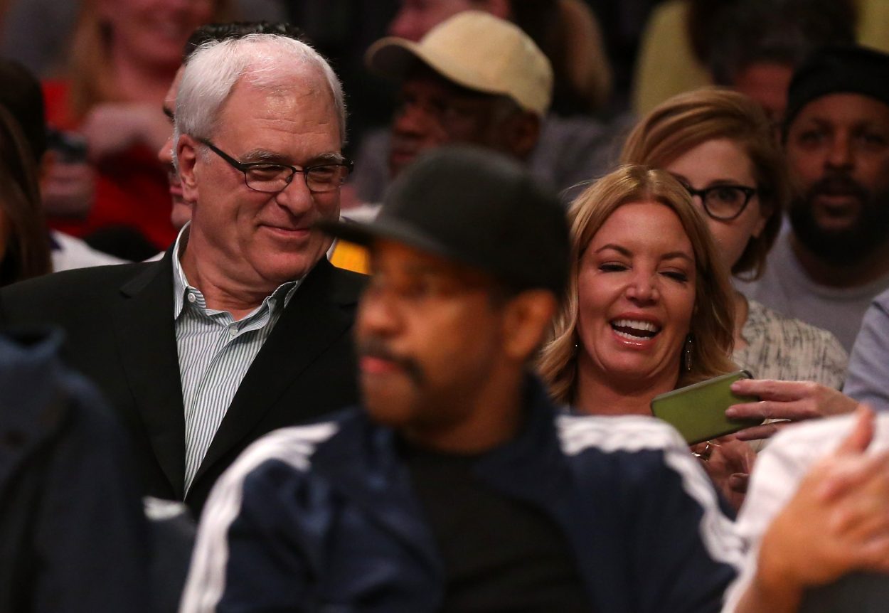 Former Los Angeles Lakers head coach Phil Jackson and Lakers governor Jeanie Buss attend an NBA game in March 2015
