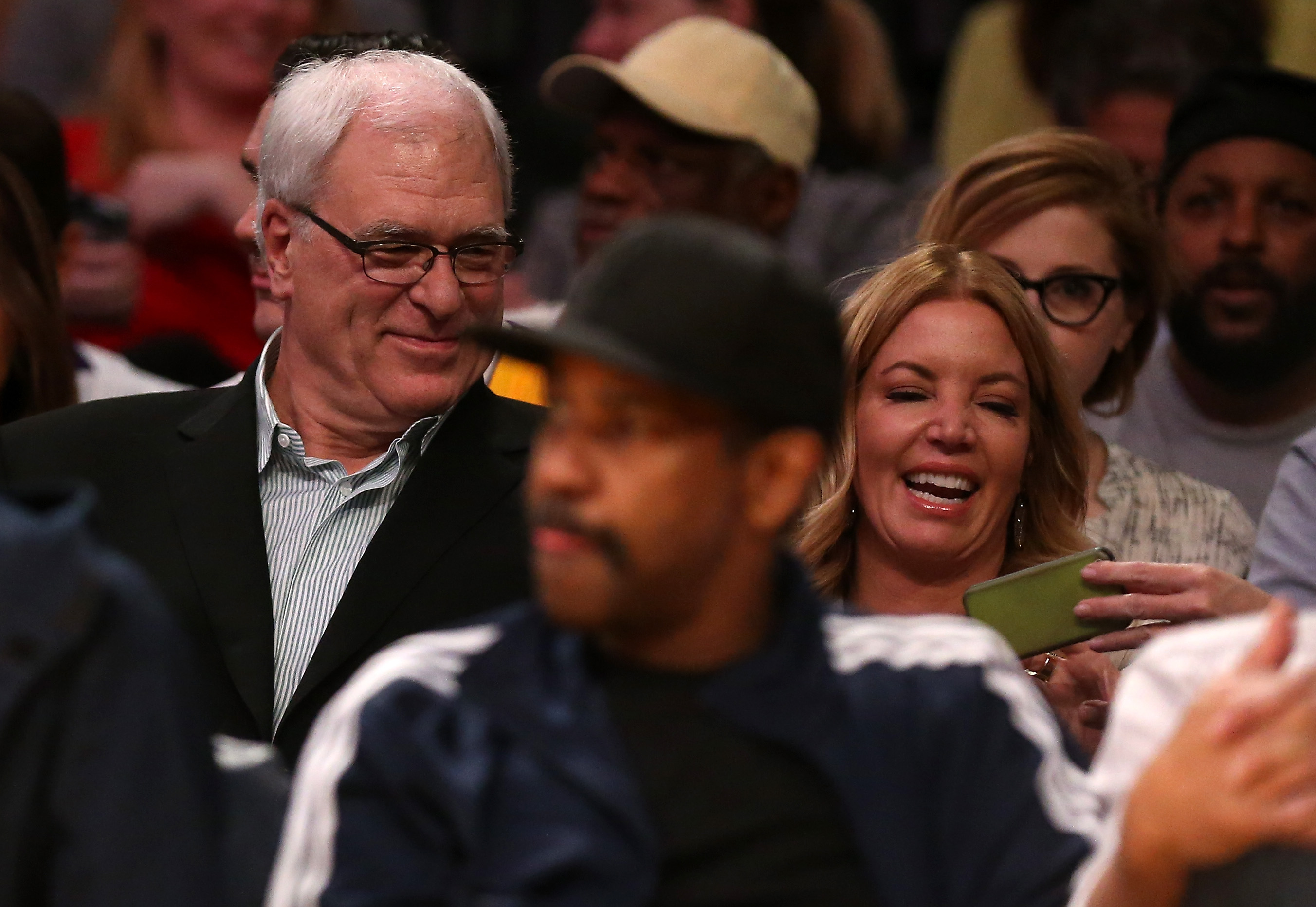 Former Los Angeles Lakers head coach Phil Jackson and Lakers governor Jeanie Buss attend an NBA game in March 2015