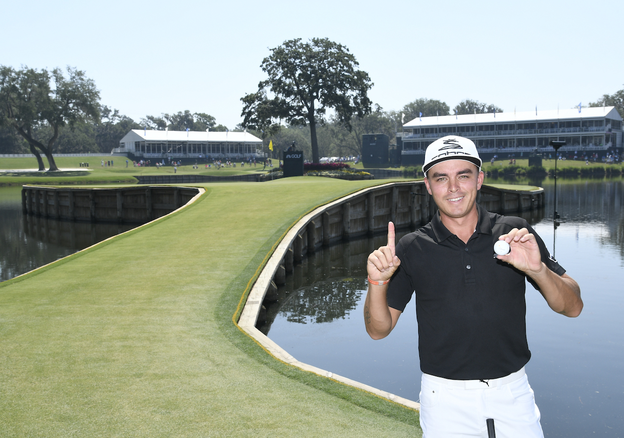 Rickie Fowler poses after making a hole-in-one.