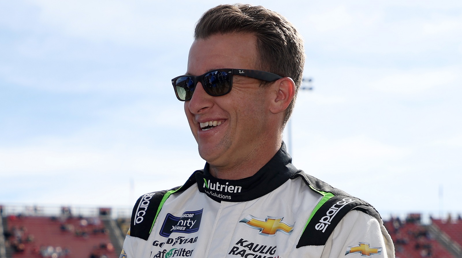 AJ Allmendinger laughs on the grid prior to the NASCAR Xfinity Series Production Alliance 300 at Auto Club Speedway on Feb. 26, 2022, in Fontana, California.