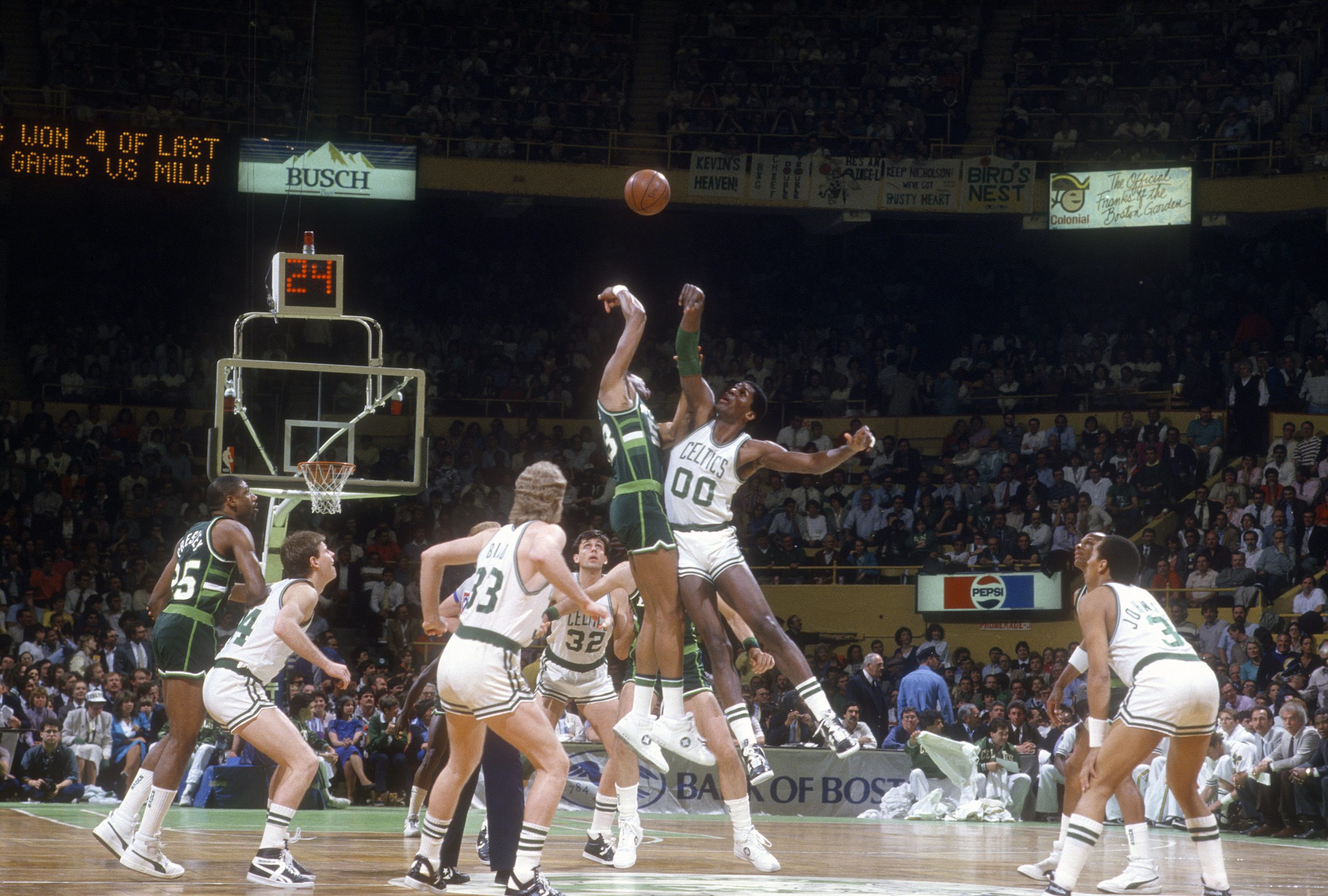 Robert Parish #00 of the Boston Celtics battles for the tip-off against the Milwaukee Bucks.