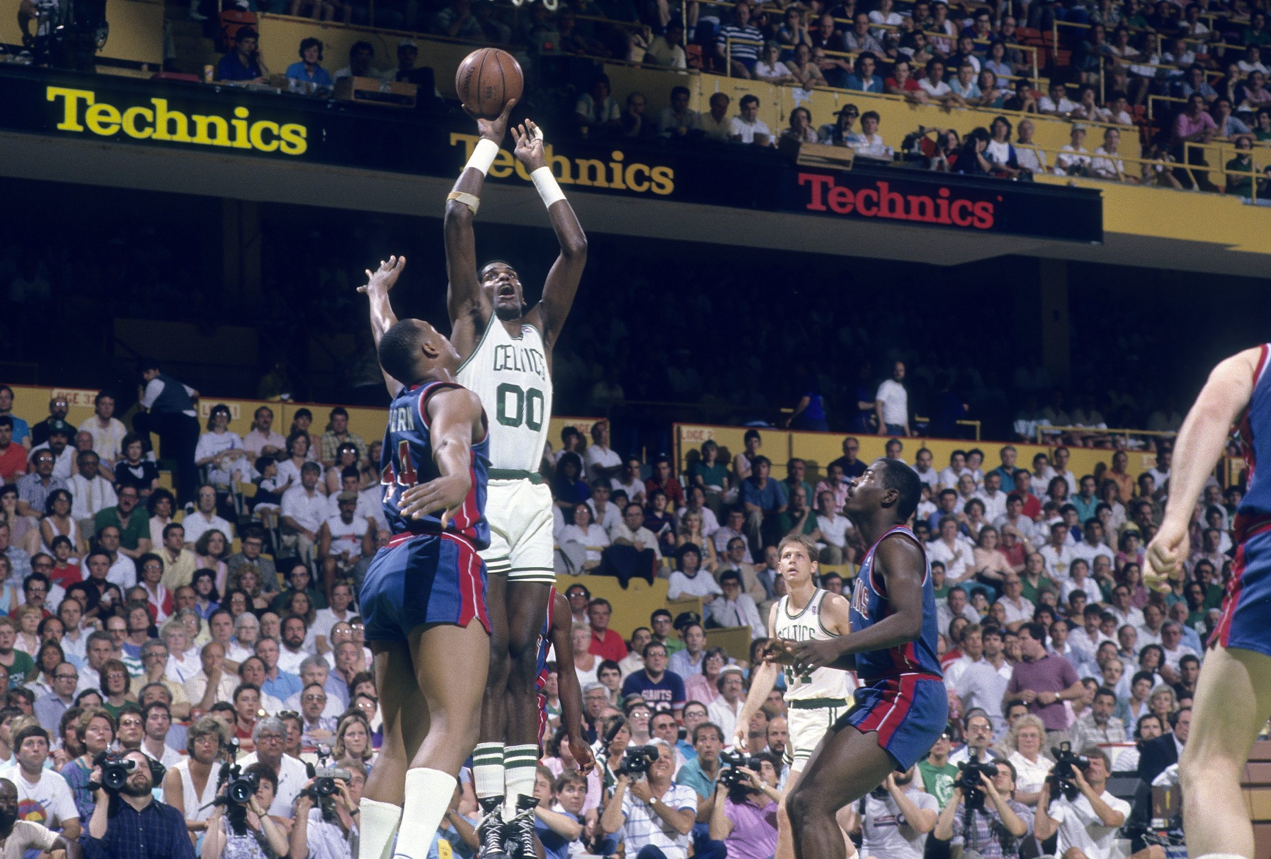 Robert Parish of the Boston Celtics shoots a jump shot over Rick Mahorn of the Detroit Pistons.
