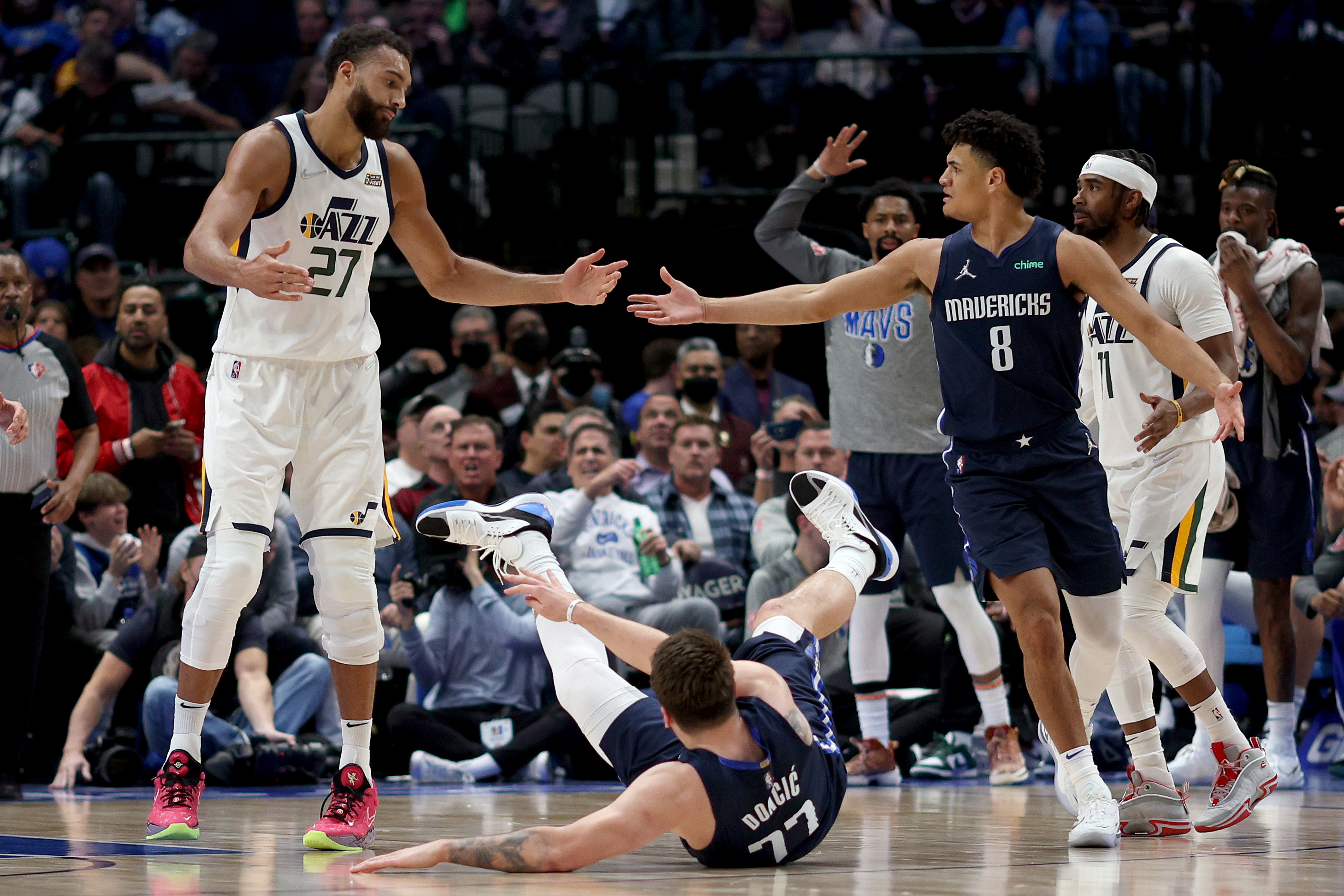 Utah Jazz center Rudy Gobert #27 shrugs after Dallas Mavericks star Luka Doncic #77 tripped over his foot during an NBA game in March 2022