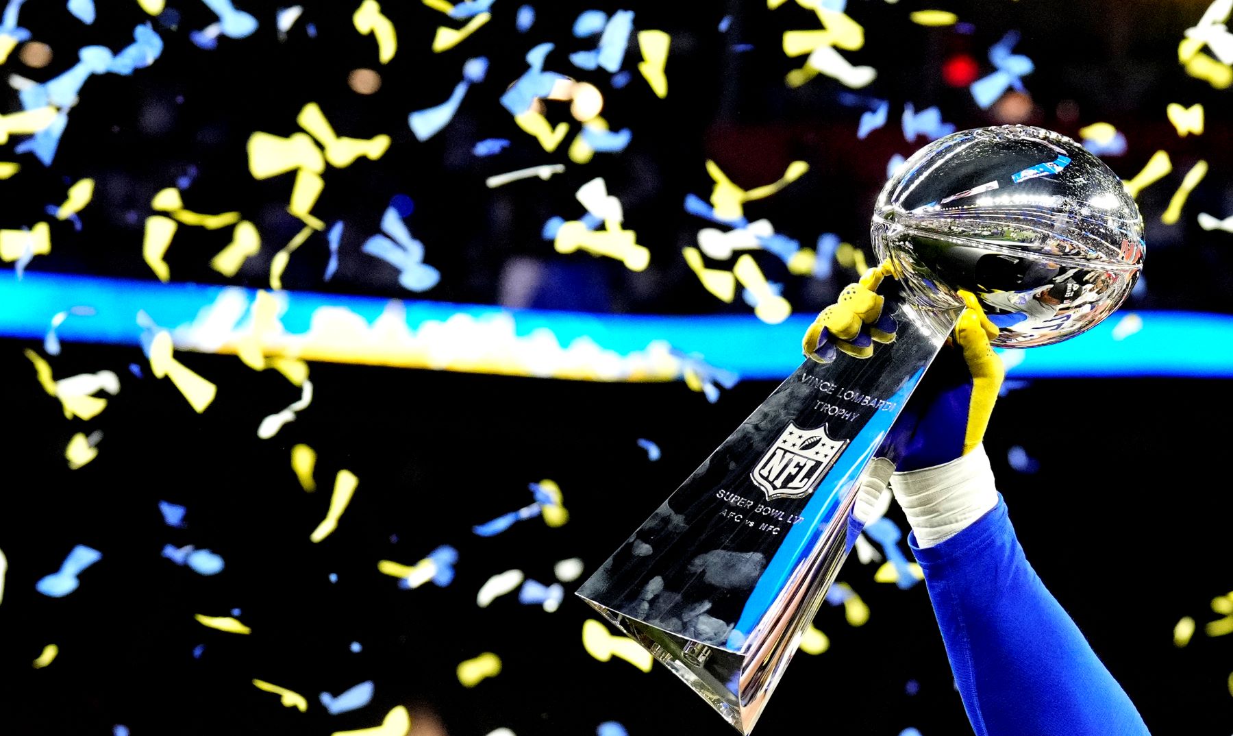 Von Miller of the Los Angeles Rams NFL team holding up the Super Bowl Vince Lombardi trophy