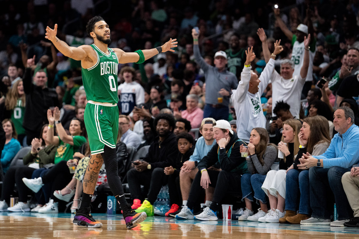 Jayson Tatum celebrates with outstretched arms for the Boston Celtics.