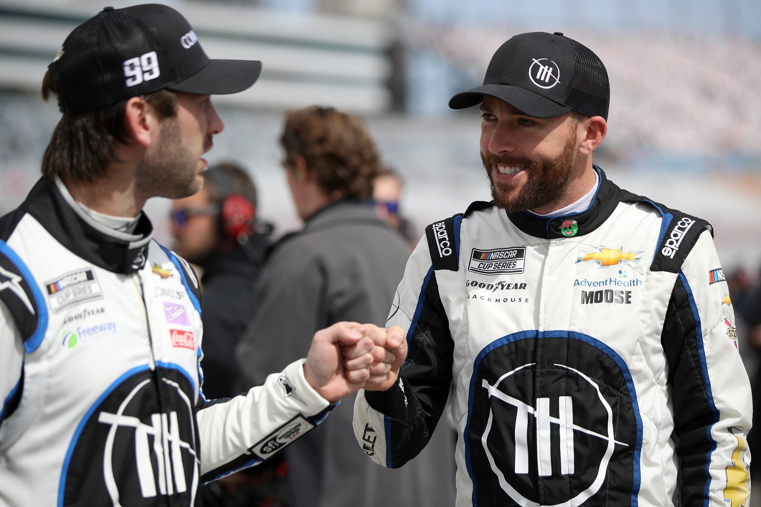 Trackhouse Racing teammates Ross Chastain, driver of the No. 1 Chevrolet, and Daniel Suarez, driver of the No. 99 Chevrolet, bump fists during qualifying for the NASCAR Cup Series Pennzoil 400 at Las Vegas Motor Speedway on March 5, 2022.