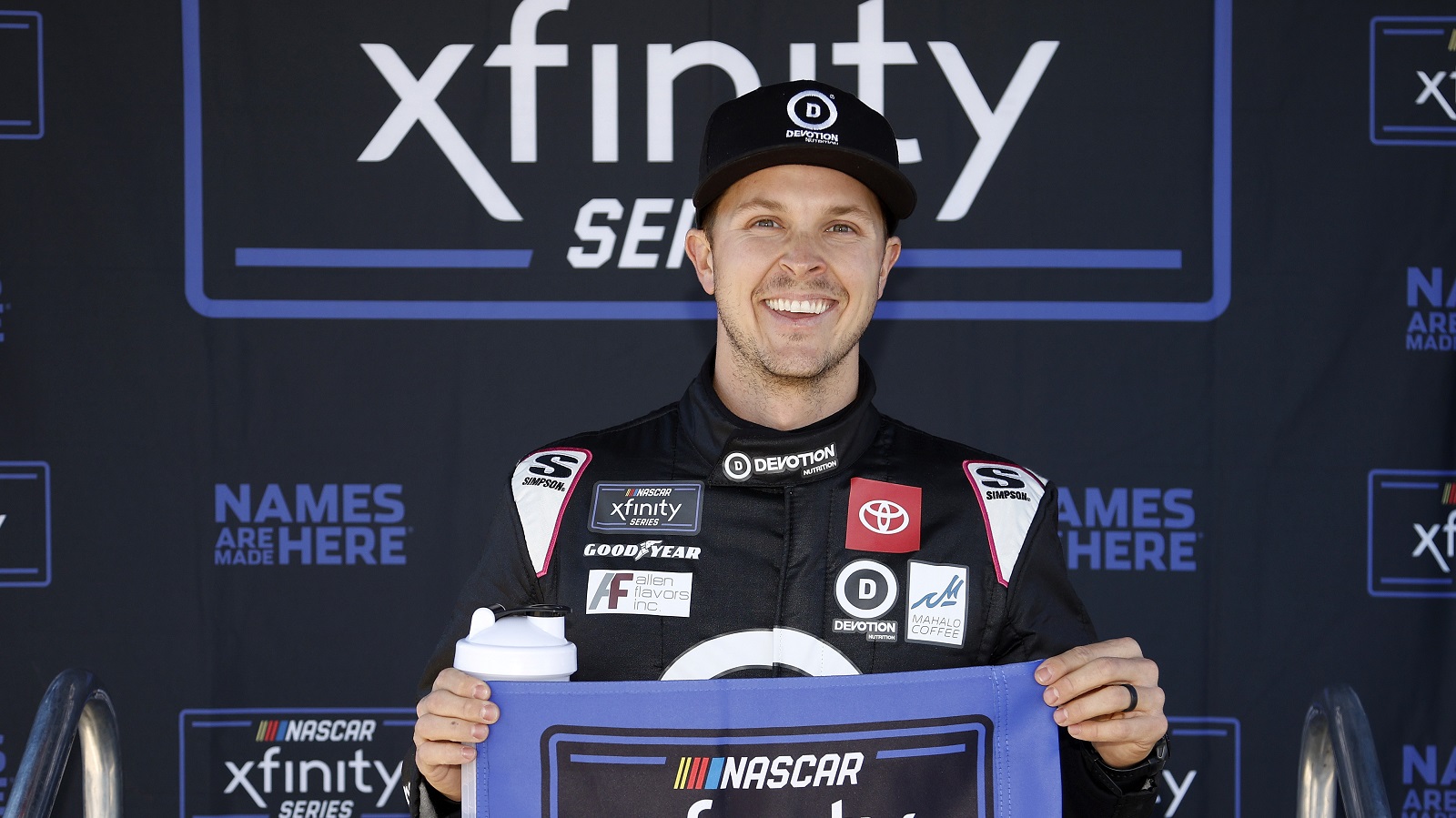Trevor Bayne, driver of the No. 18 Toyota for Joe Gibbs Racing, poses for photos after winning the pole in qualifying for the NASCAR Xfinity Series United Rentals 200 at Phoenix Raceway on March 12, 2022.
