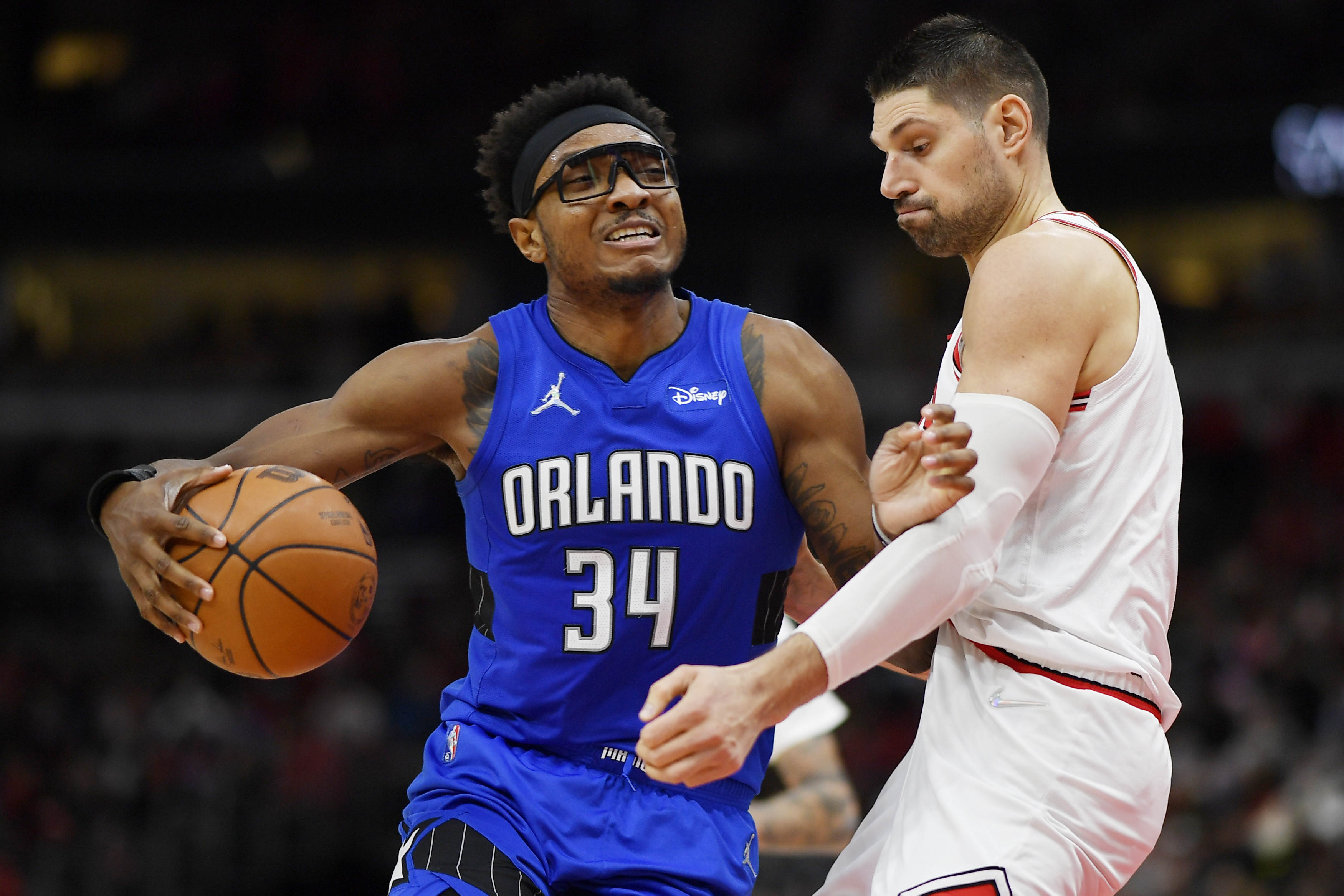 Orlando Magic center Wendell Carter Jr. #34 backs down Chicago Bulls big man Nikola Vucevic during an NBA game in January 2022