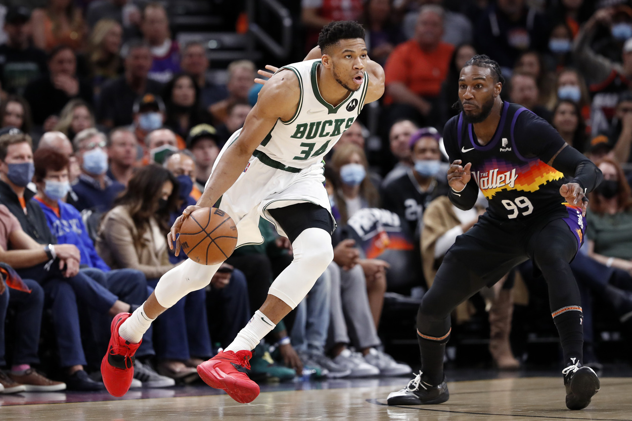 Milwaukee Bucks star Giannis Antetokounmpo tries to drive past Phoenix Suns forward Jae Crowder.