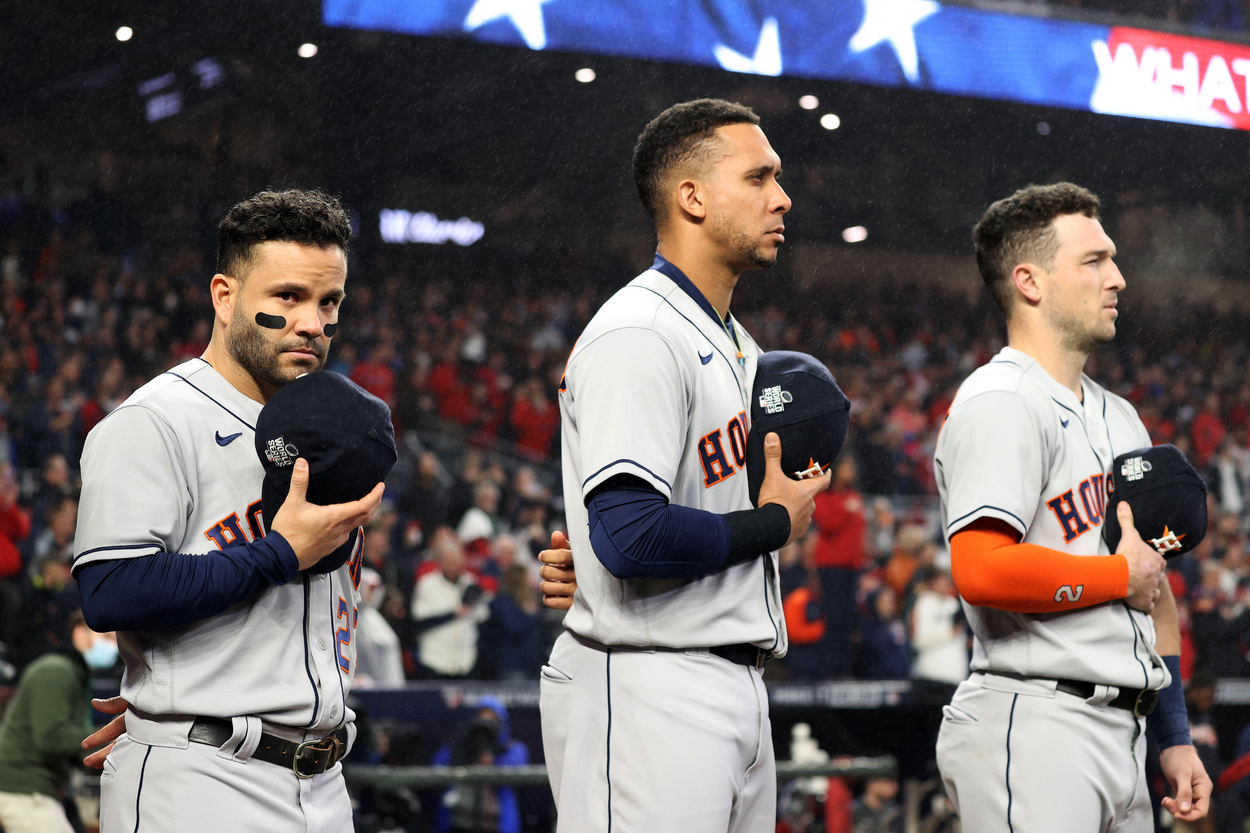 Houston Astros stars Jose Altuve, Michael Brantley, and Alex Bregman stand at attention during the national anthem.