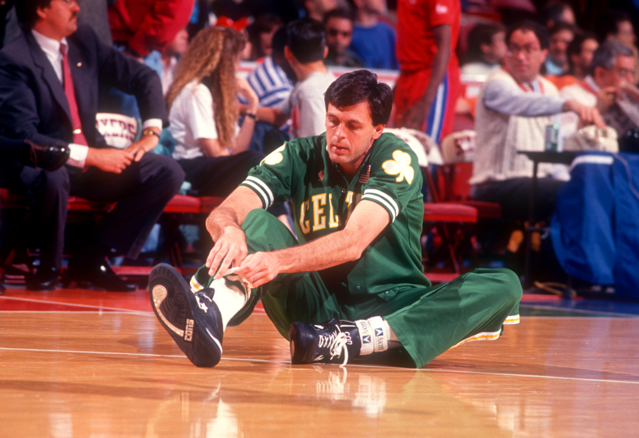 Kevin McHale of the Boston Celtics ties his shoes during warm-ups prior to an NBA game against the Philadelphia 76ers on April 18, 1991, at the Spectrum in Philadelphia, Pennsylvania.