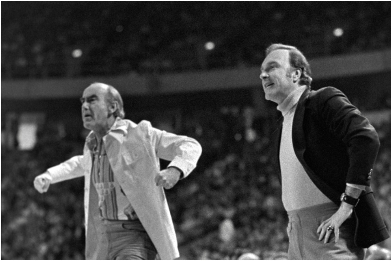Portland Trail Blazers coaches Jack Ramsay and Jack McKinney stand in front of the bench and yell onto the court.