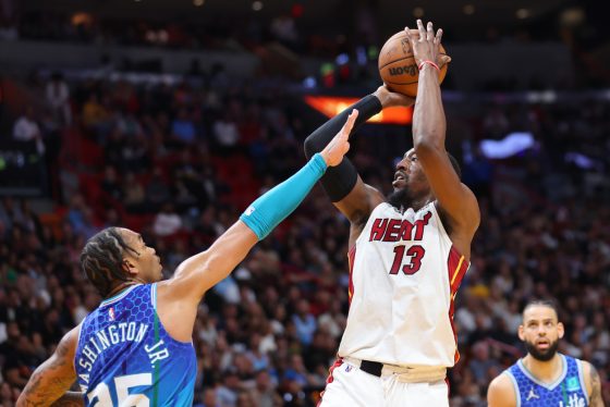 Bam Adebayo of the Miami Heat shoots over P.J. Washington of the Charlotte Hornets.