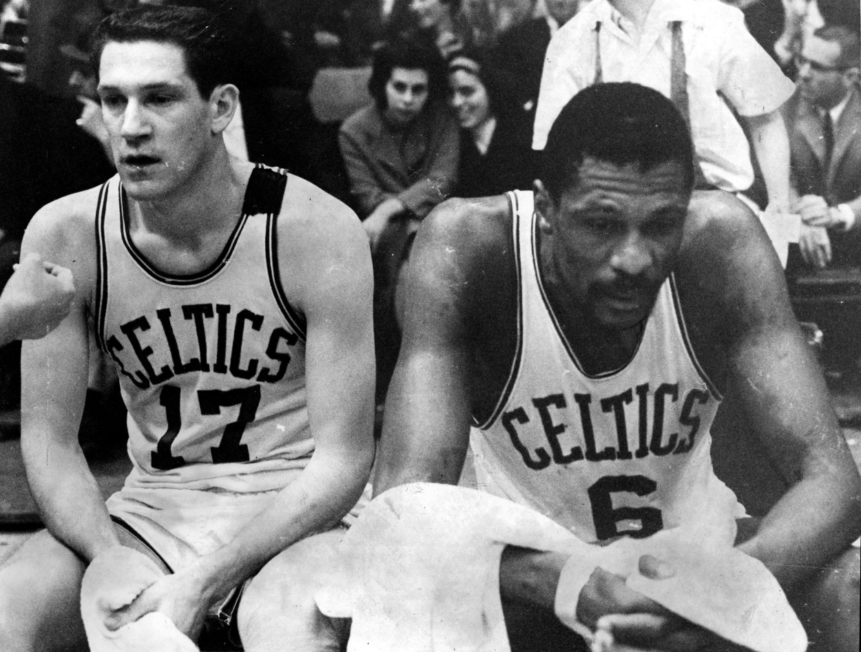 Boston Celtics John Havlicek, left, and Bill Russell, right, take a break on the bench during a game against the Philadelphia 76ers, April 15, 1965.