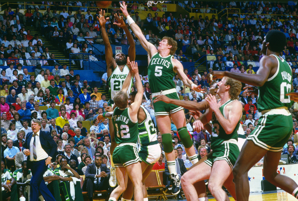 Bill Walton of the Boston Celtics goes up to block the shot of Paul Pressey of the Milwaukee Bucks.